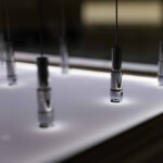 This is a zoomed-in photo of the tension sets mounted on an Acrylic LED panel at the base.