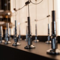 The chrome wine racking pegs and cables fits nicely to this glass wine cellar. Modern Chrome Wine Cellar Cable Racking